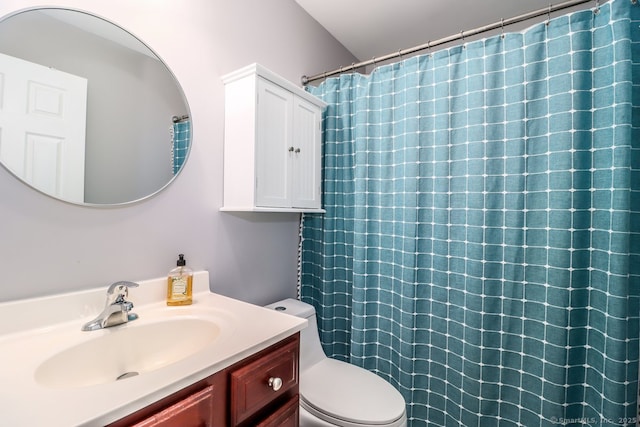 bathroom with toilet, curtained shower, and vanity