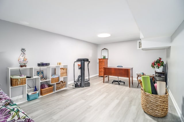 interior space with baseboards and wood finished floors