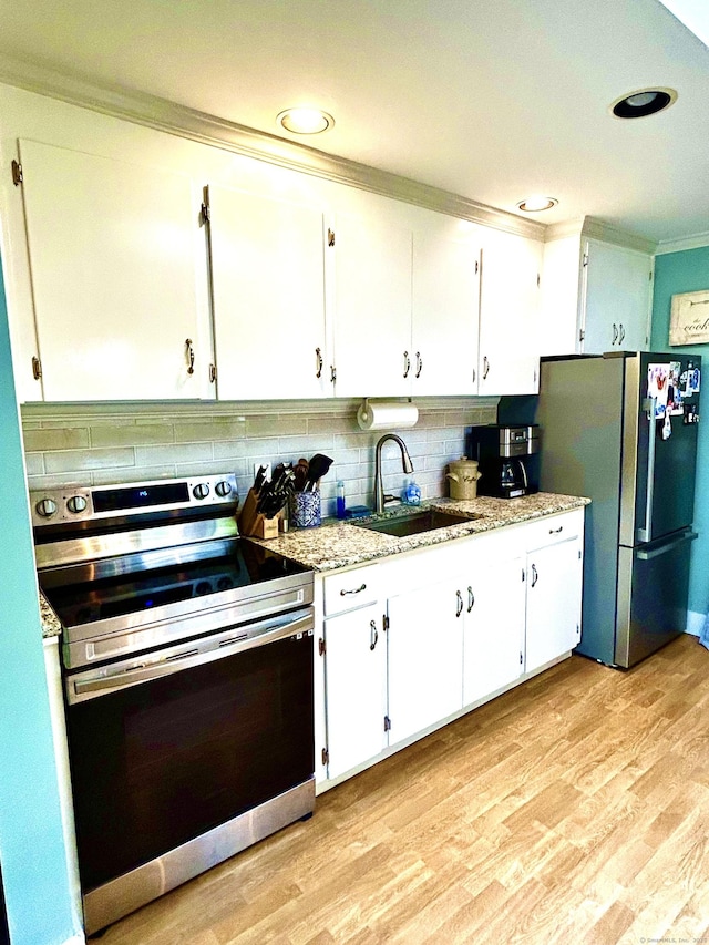18 Paul St, Danbury, CT 06810 - kitchen featuring appliances with stainless steel finishes, ornamental molding, a sink, decorative backsplash, and white cabinets