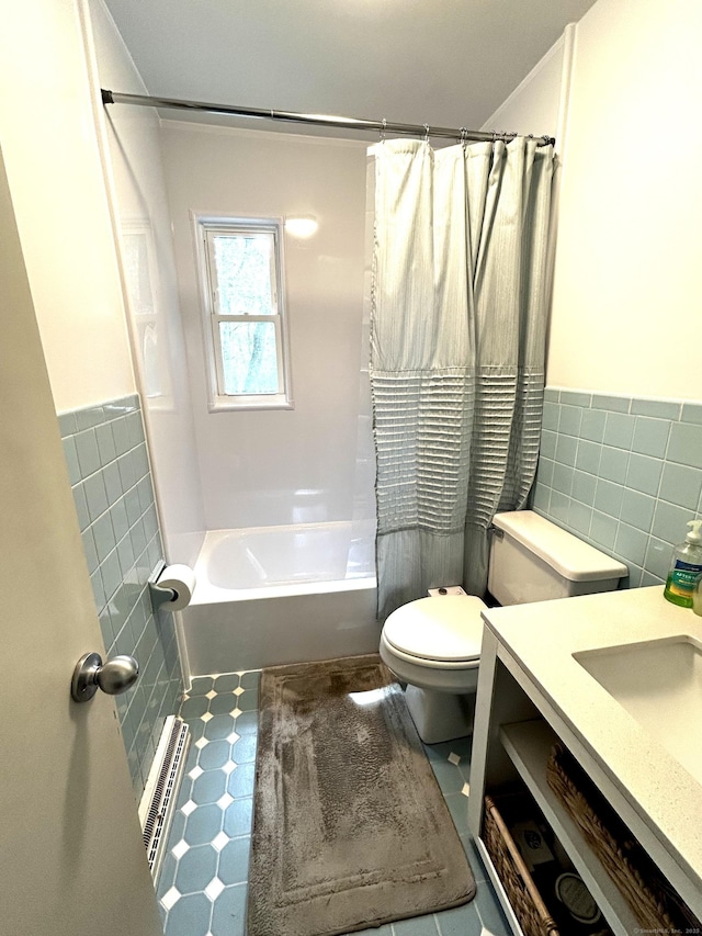 18 Paul St, Danbury, CT 06810 - bathroom with tile walls, shower / bath combo, toilet, vanity, and a wainscoted wall