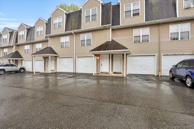 multi unit property with a shingled roof and a residential view