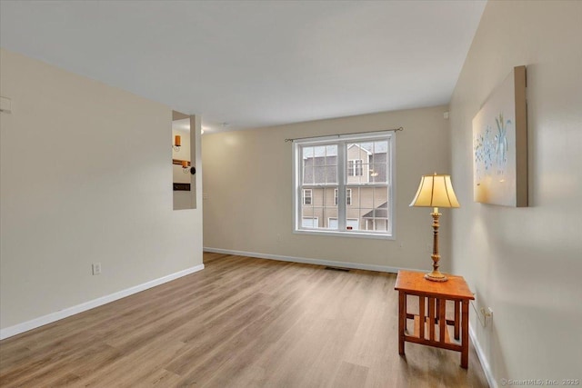 unfurnished room with wood finished floors and baseboards