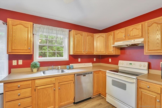 kitchen featuring stainless steel dishwasher, white electric range, a sink, under cabinet range hood, and light countertops