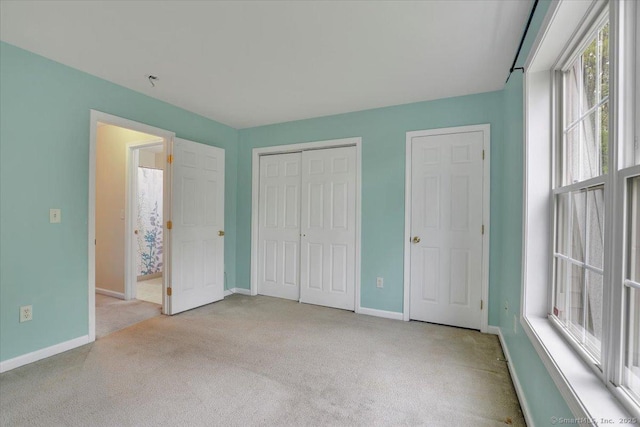 unfurnished bedroom featuring carpet flooring and baseboards