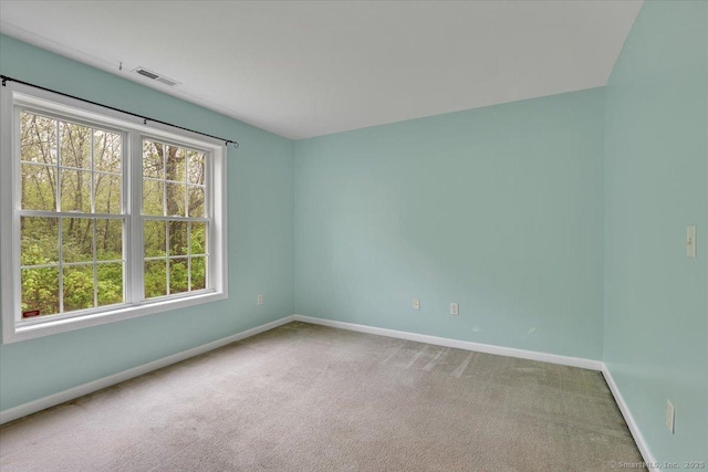spare room featuring baseboards and carpet