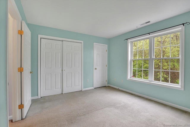 unfurnished bedroom with baseboards and carpet