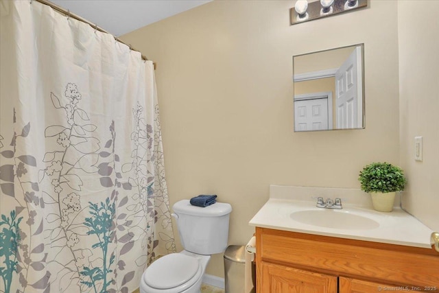 full bath featuring toilet, vanity, and curtained shower