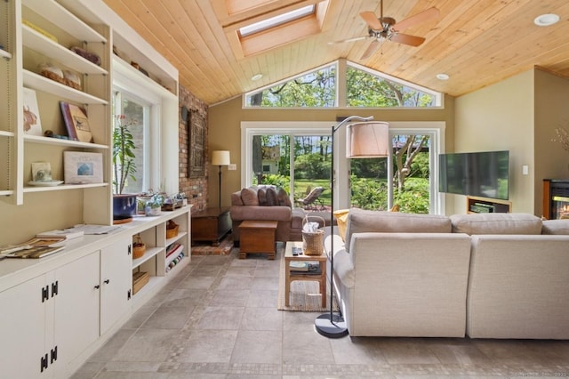 living room featuring wood ceiling, a skylight, lofted ceiling, and a ceiling fan
