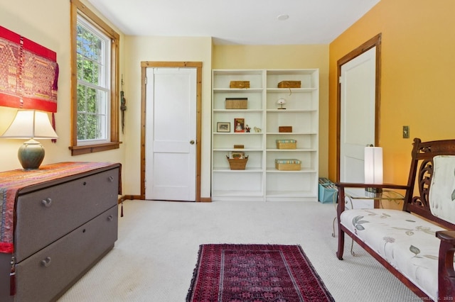 sitting room featuring carpet flooring and baseboards