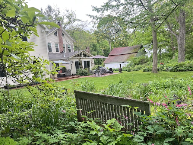 view of grassy yard with a wooden deck
