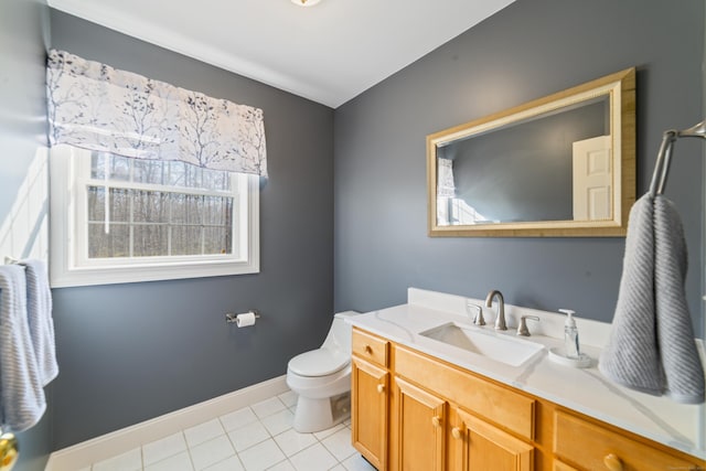 bathroom featuring vanity, toilet, tile patterned flooring, and baseboards