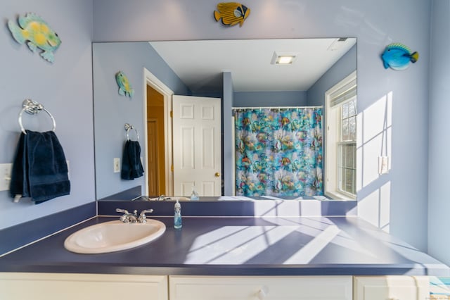 bathroom featuring a shower with curtain and vanity