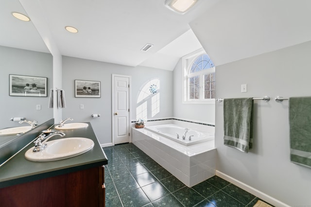 bathroom with lofted ceiling, tile patterned flooring, baseboards, and a sink