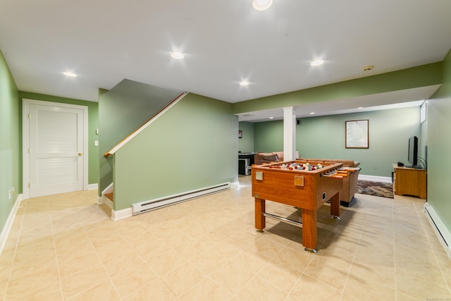 rec room featuring a baseboard heating unit, a baseboard radiator, baseboards, and recessed lighting