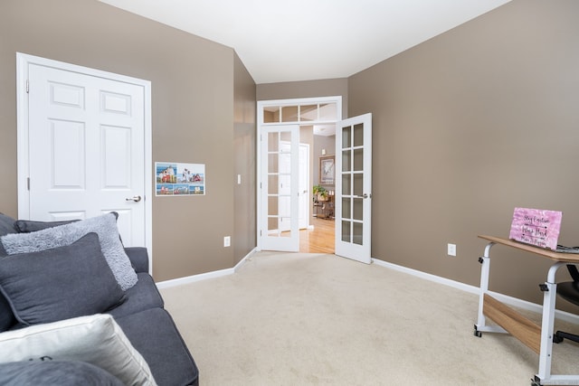 interior space with french doors, baseboards, and light colored carpet