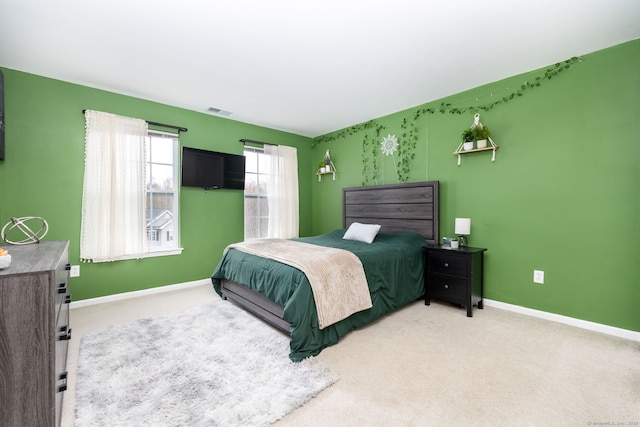 bedroom featuring visible vents, baseboards, and carpet floors