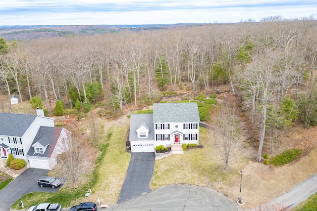 birds eye view of property with a view of trees