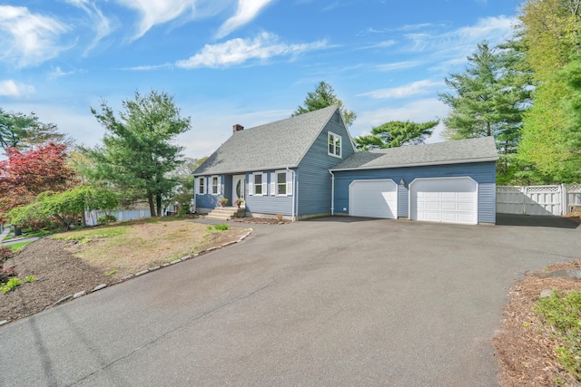 63 Rita Dr, Bristol, CT 06010 - new england style home with fence, a chimney, asphalt driveway, roof with shingles, and an attached garage