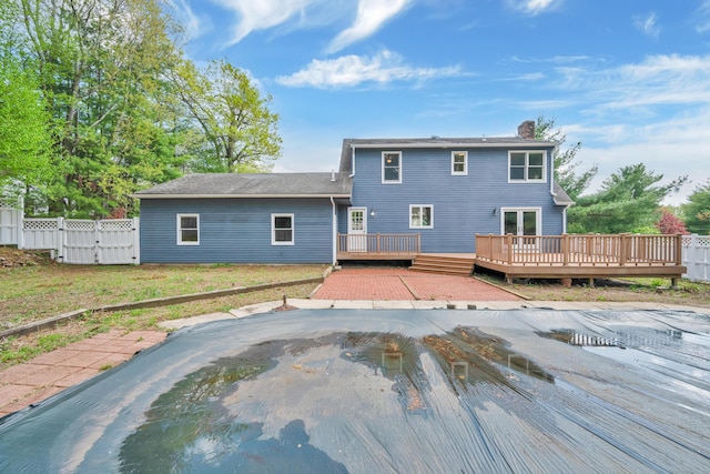 63 Rita Dr, Bristol, CT 06010 - rear view of property featuring a deck, a chimney, fence, and a gate