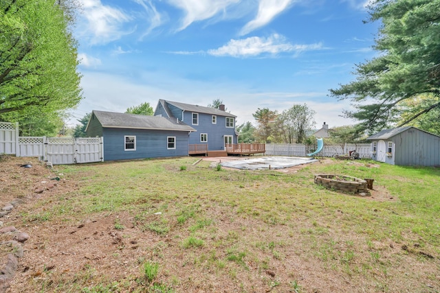 63 Rita Dr, Bristol, CT 06010 - view of yard featuring a fire pit, a wooden deck, a storage shed, a gate, and an outdoor structure