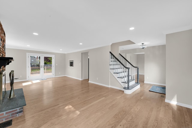 63 Rita Dr, Bristol, CT 06010 - unfurnished living room with baseboards, light wood-type flooring, recessed lighting, stairway, and a brick fireplace