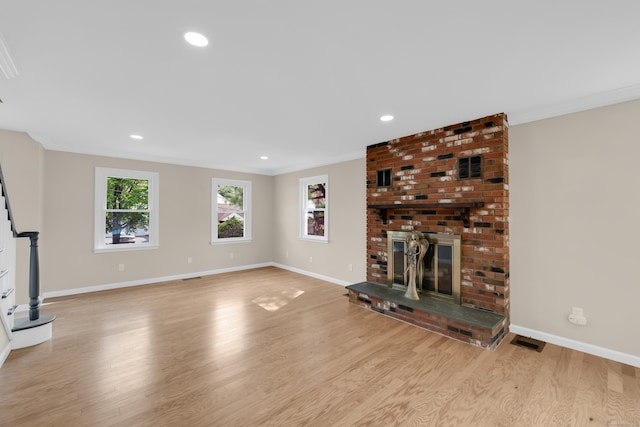 63 Rita Dr, Bristol, CT 06010 - unfurnished living room with light wood-style flooring, a brick fireplace, baseboards, crown molding, and recessed lighting