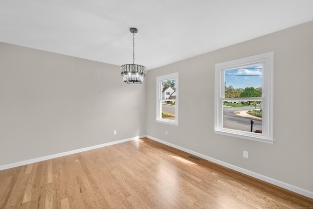 63 Rita Dr, Bristol, CT 06010 - empty room with a chandelier, light wood-style flooring, and baseboards