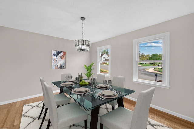63 Rita Dr, Bristol, CT 06010 - dining area featuring a chandelier, light wood-style flooring, and baseboards