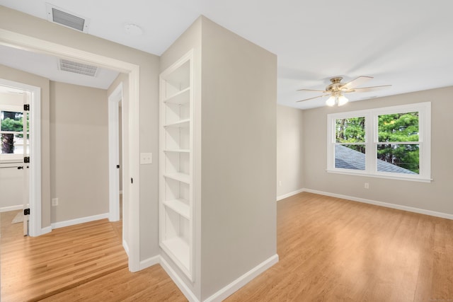 63 Rita Dr, Bristol, CT 06010 - empty room with light wood-type flooring, baseboards, a ceiling fan, and built in shelves