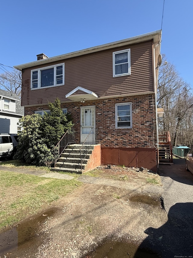 186 York St, West Haven, CT 06516 - colonial house with brick siding and a chimney