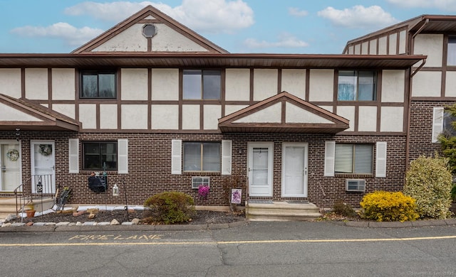 view of front of house with brick siding and stucco siding