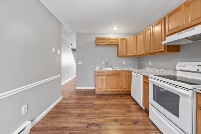 kitchen with a baseboard radiator, a sink, white appliances, dark wood finished floors, and under cabinet range hood