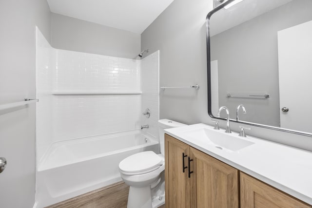 bathroom with wood finished floors, toilet, vanity, and bathtub / shower combination