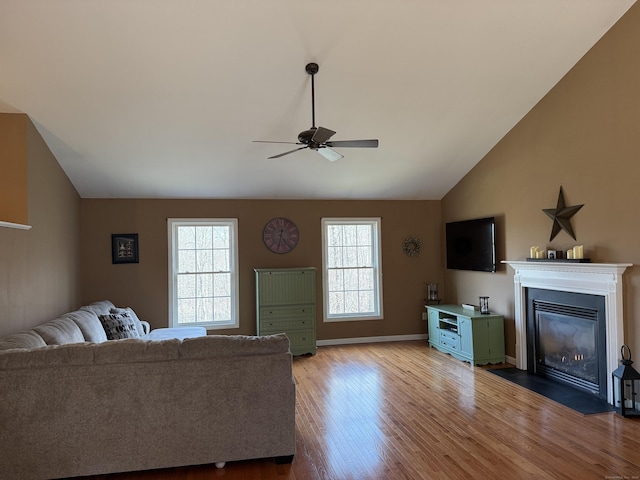 2 Anita Way, Warren, CT 06754 - living area with lofted ceiling, ceiling fan, plenty of natural light, wood finished floors, and a fireplace with flush hearth