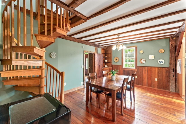 11 Glen Rd, Newtown, CT 06482 - dining area featuring wooden walls, stairs, a wainscoted wall, hardwood / wood-style flooring, and beamed ceiling