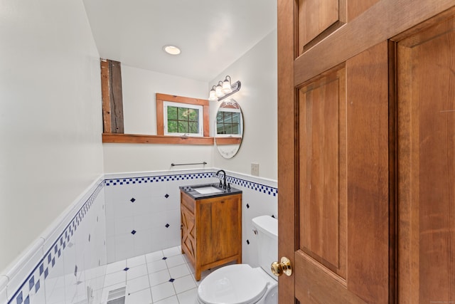 11 Glen Rd, Newtown, CT 06482 - half bathroom with wainscoting, toilet, vanity, and tile walls