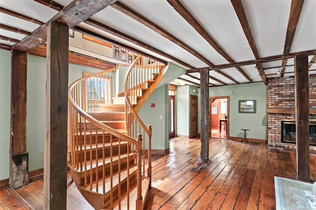 11 Glen Rd, Newtown, CT 06482 - stairs featuring wood-type flooring, baseboards, beamed ceiling, and a fireplace