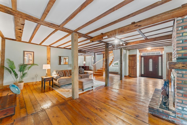 11 Glen Rd, Newtown, CT 06482 - living room with stairway, wood-type flooring, baseboards, beamed ceiling, and a fireplace