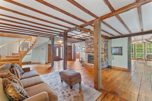 11 Glen Rd, Newtown, CT 06482 - living area featuring hardwood / wood-style flooring, a chandelier, baseboards, stairway, and a brick fireplace