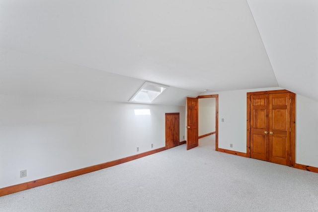 11 Glen Rd, Newtown, CT 06482 - additional living space featuring a skylight, lofted ceiling, baseboards, and light colored carpet