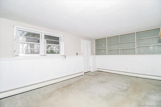 6 Pell Mell Dr, Bethel, CT 06801 - empty room with concrete floors, a wainscoted wall, and a baseboard heating unit