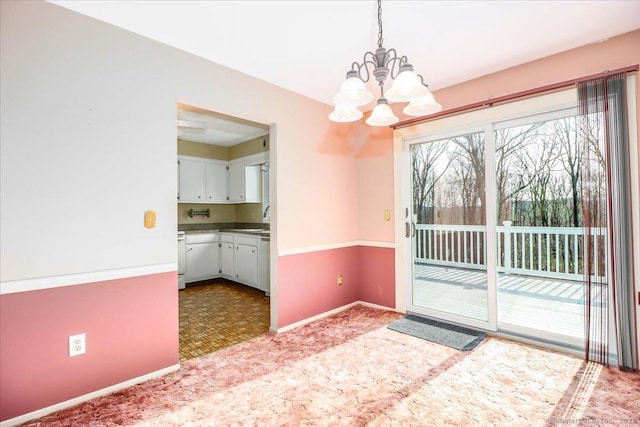 6 Pell Mell Dr, Bethel, CT 06801 - unfurnished dining area featuring a sink, baseboards, carpet, and an inviting chandelier