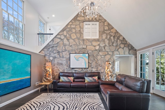 living room featuring an inviting chandelier and high vaulted ceiling