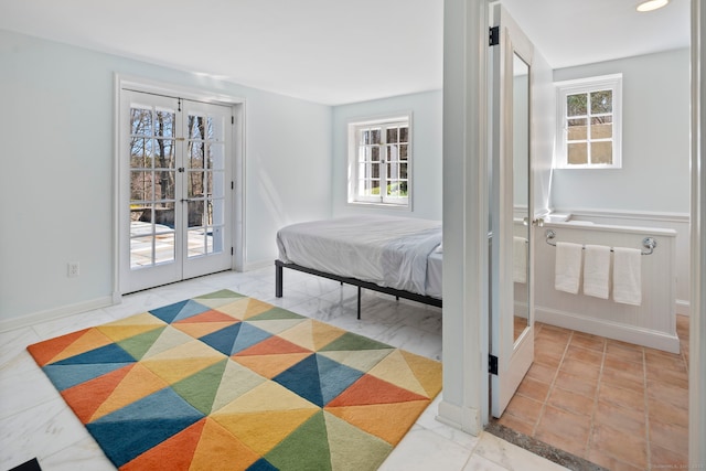 bedroom featuring baseboards, access to outside, french doors, and multiple windows