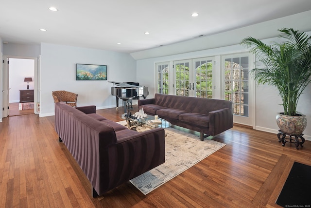 living room with recessed lighting, wood finished floors, visible vents, and french doors