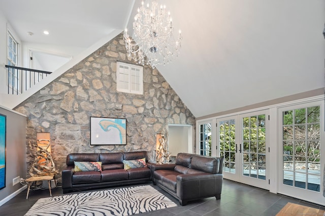 living room featuring high vaulted ceiling, french doors, and a chandelier