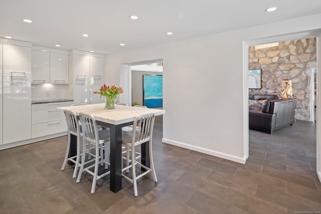 dining space featuring baseboards and recessed lighting