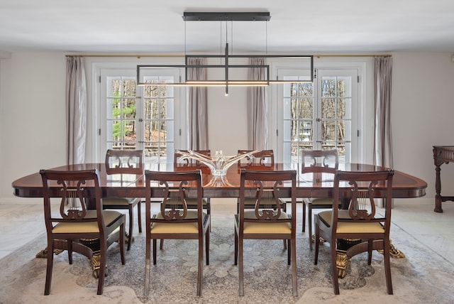 dining room with marble finish floor and baseboards
