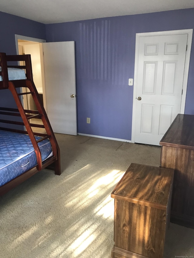 bedroom with baseboards and carpet floors