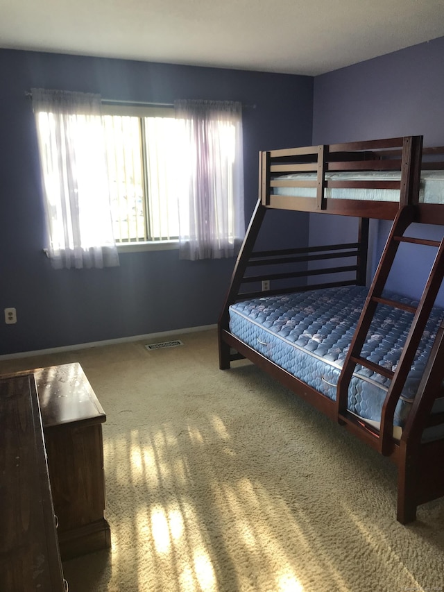 bedroom featuring carpet flooring, baseboards, and visible vents